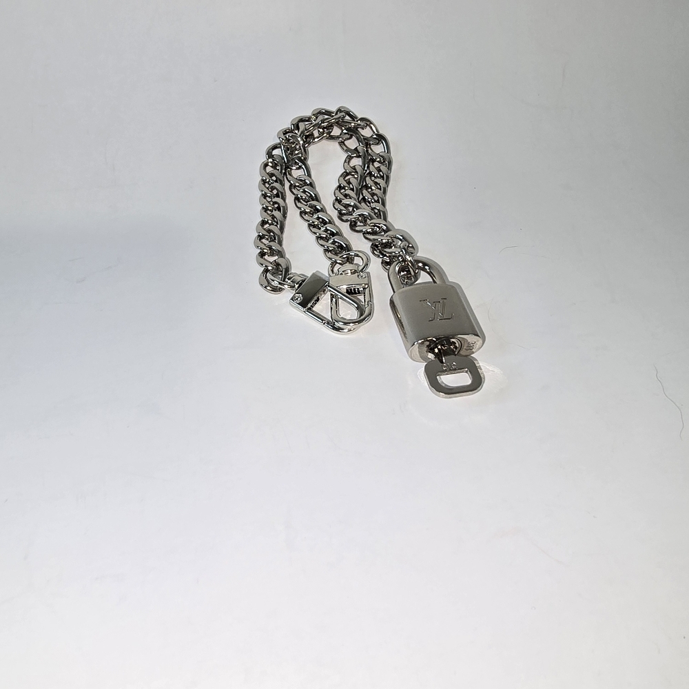 Silver unbranded chain with authentic silver LV lock and key